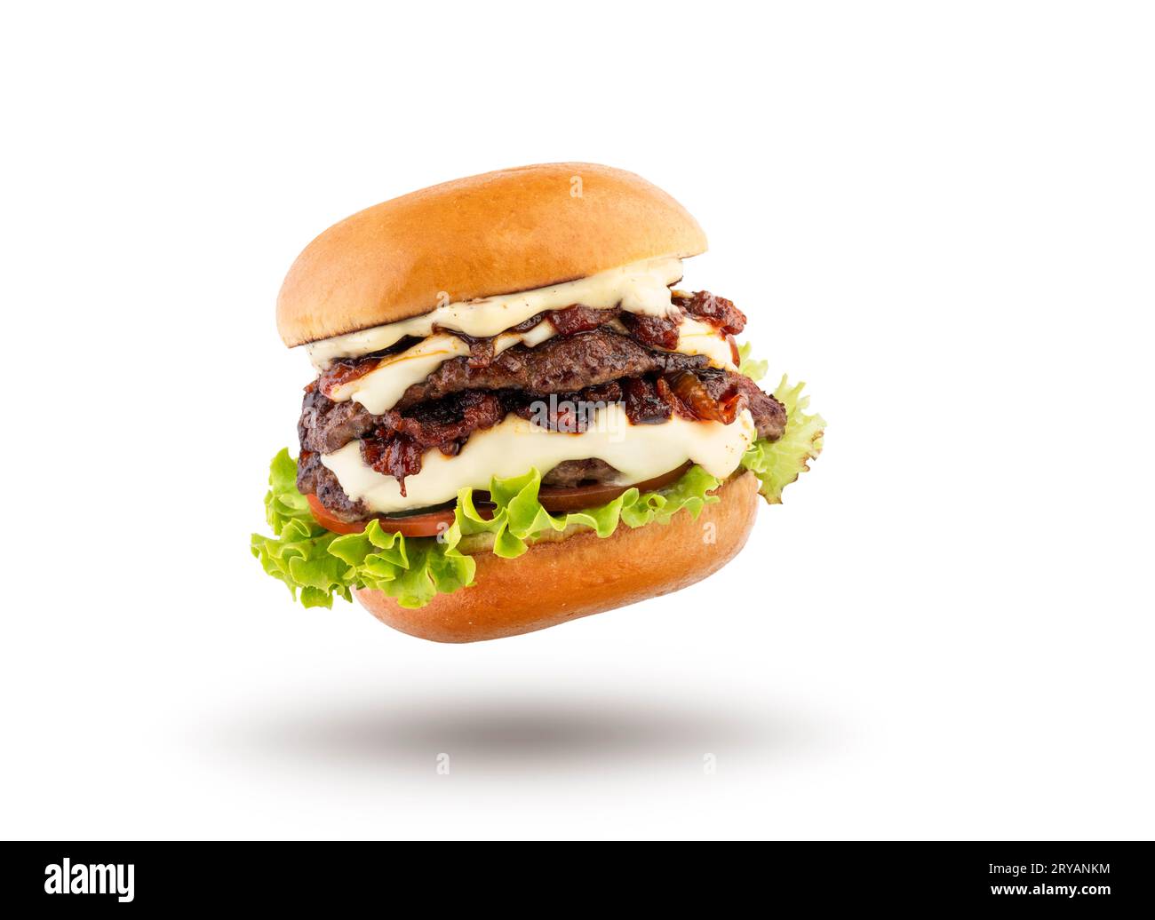 Classic hamburger with grilled meat jumping on white background. Stock Photo