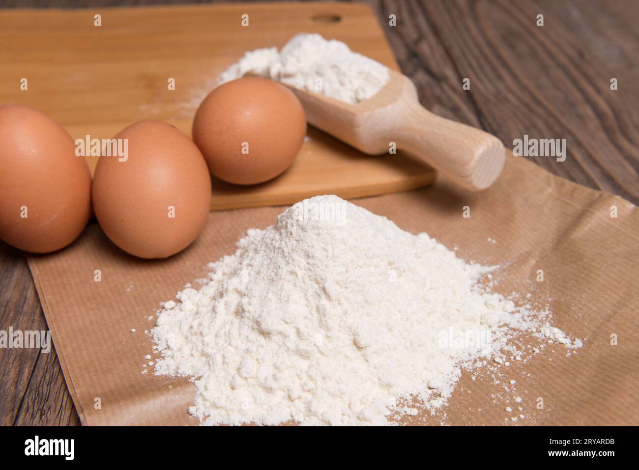 Flour spoon and eggs Stock Photo - Alamy