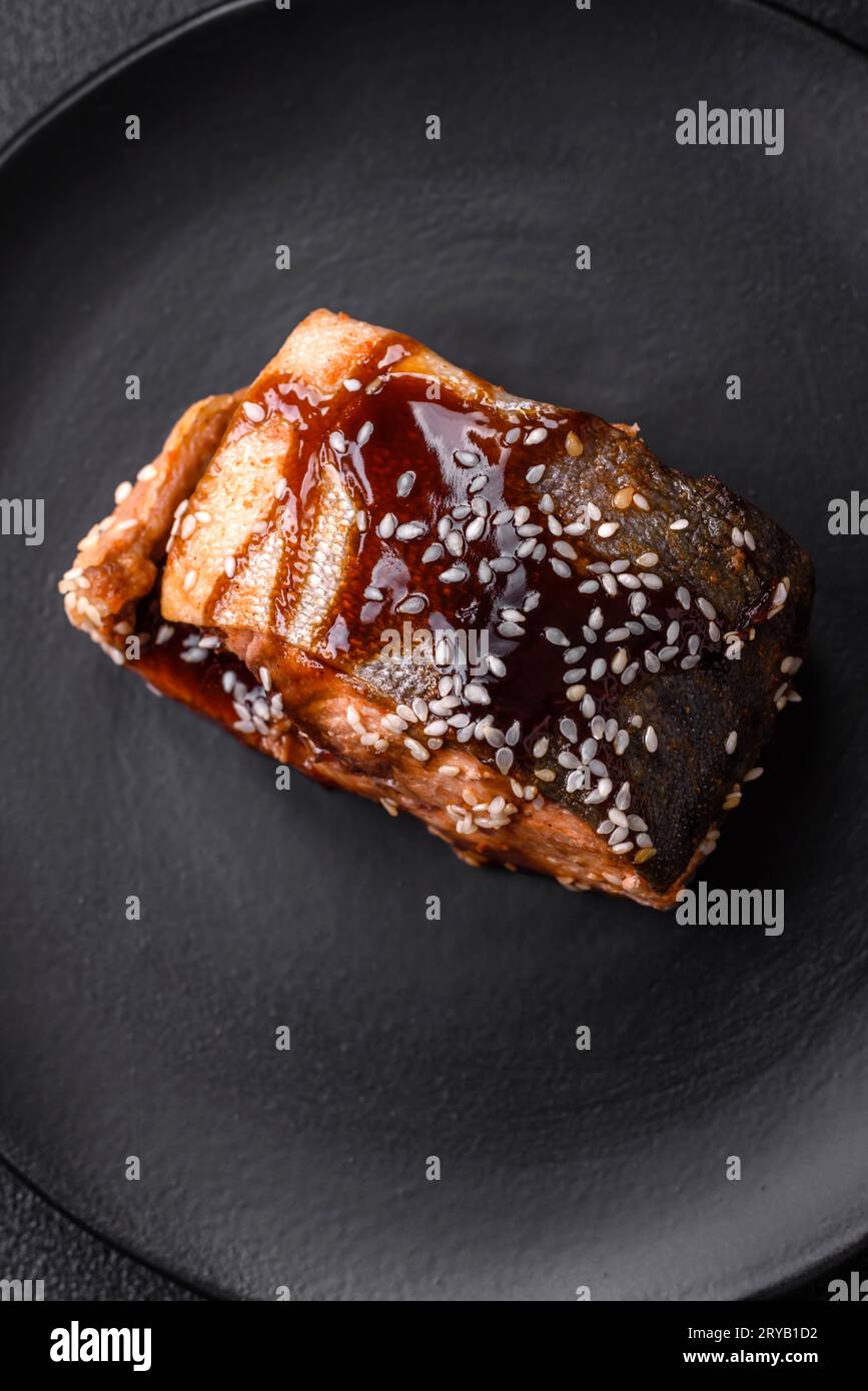 Delicious grilled salmon fillet with salt, spices, herbs and sauce on a ...