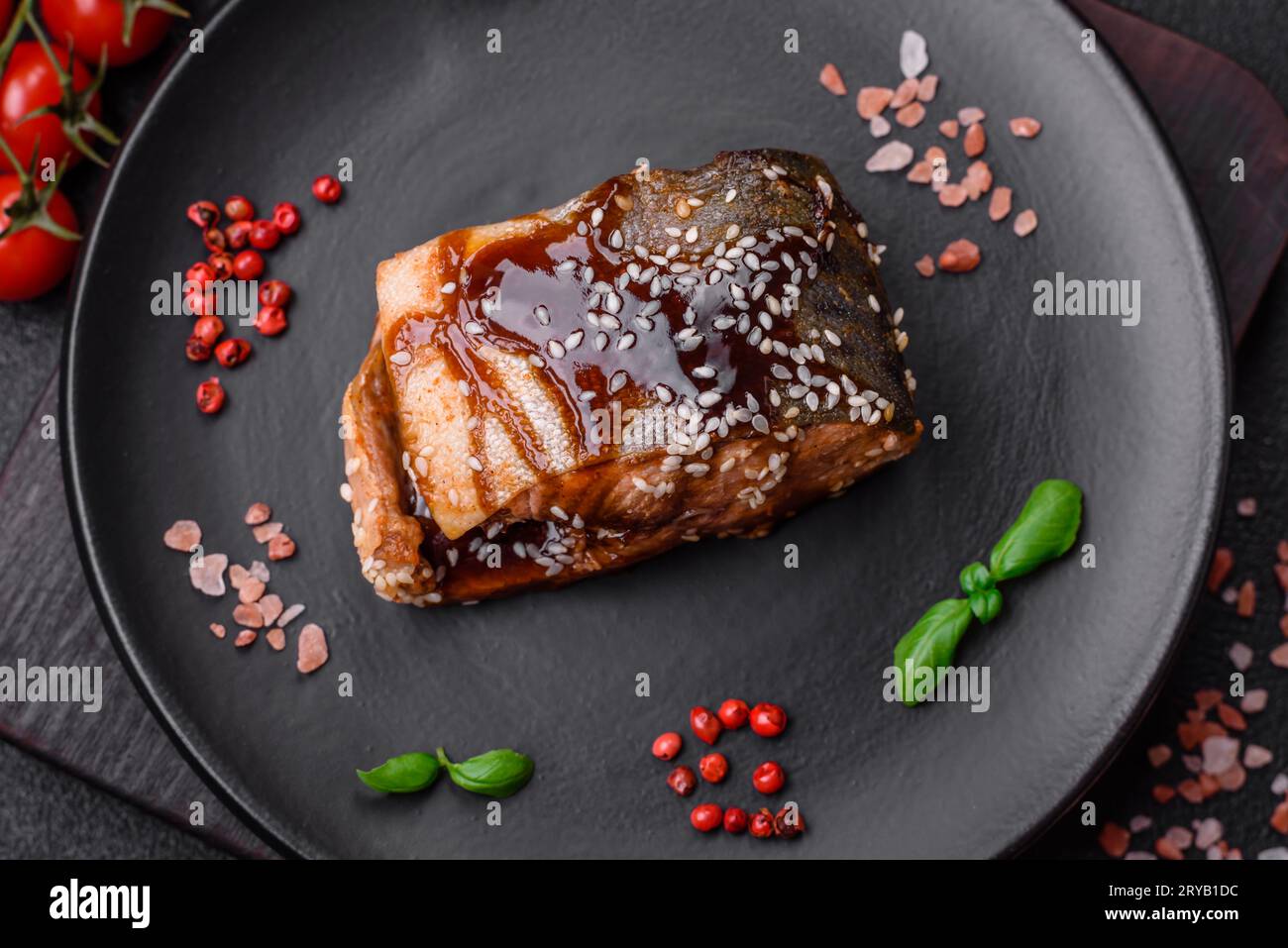 Delicious grilled salmon fillet with salt, spices, herbs and sauce on a ...