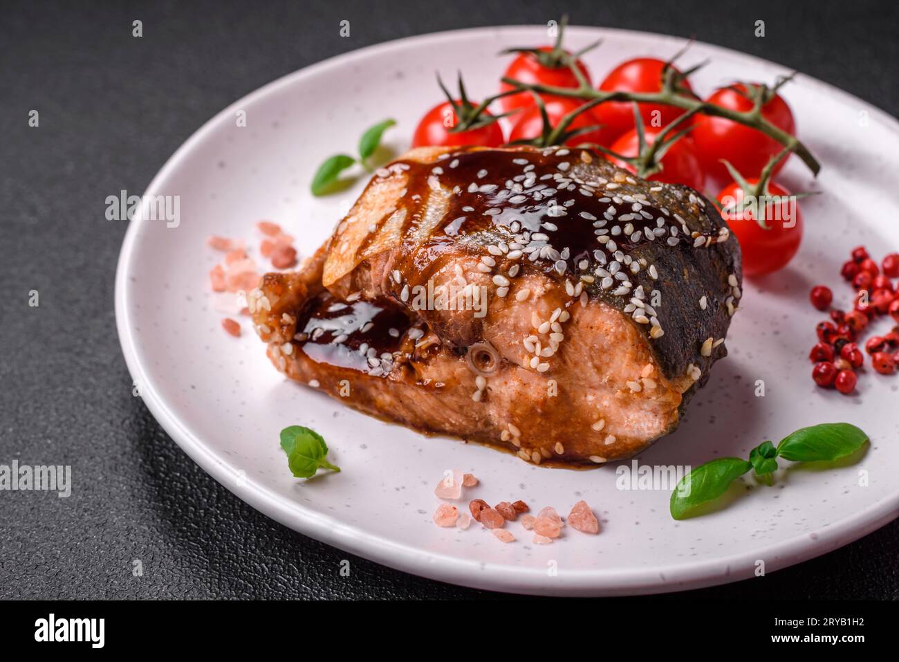 Delicious grilled salmon fillet with salt, spices, herbs and sauce on a ...