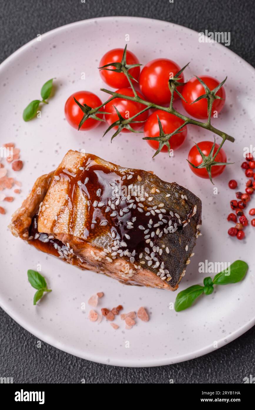 Delicious grilled salmon fillet with salt, spices, herbs and sauce on a ...