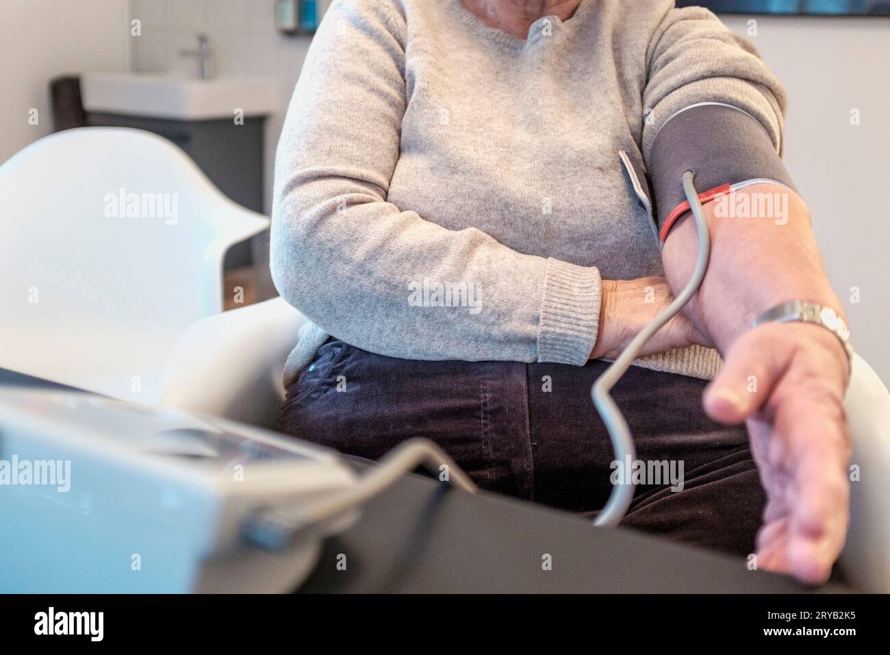 Senior woman , having her blood presure checked , GP practice Stock Photo