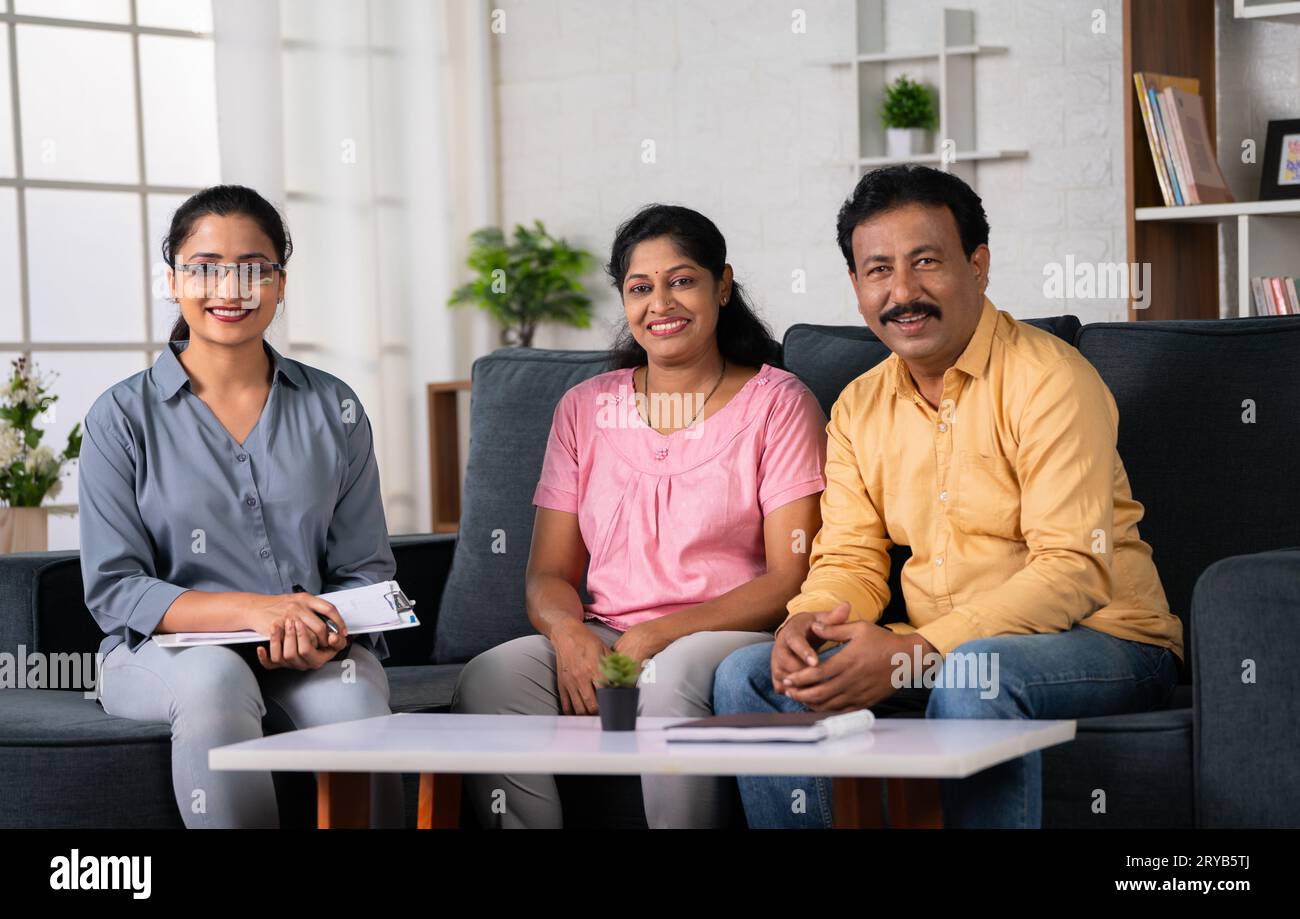 Portrait shot of Happy indian psychologist with middle aged couple