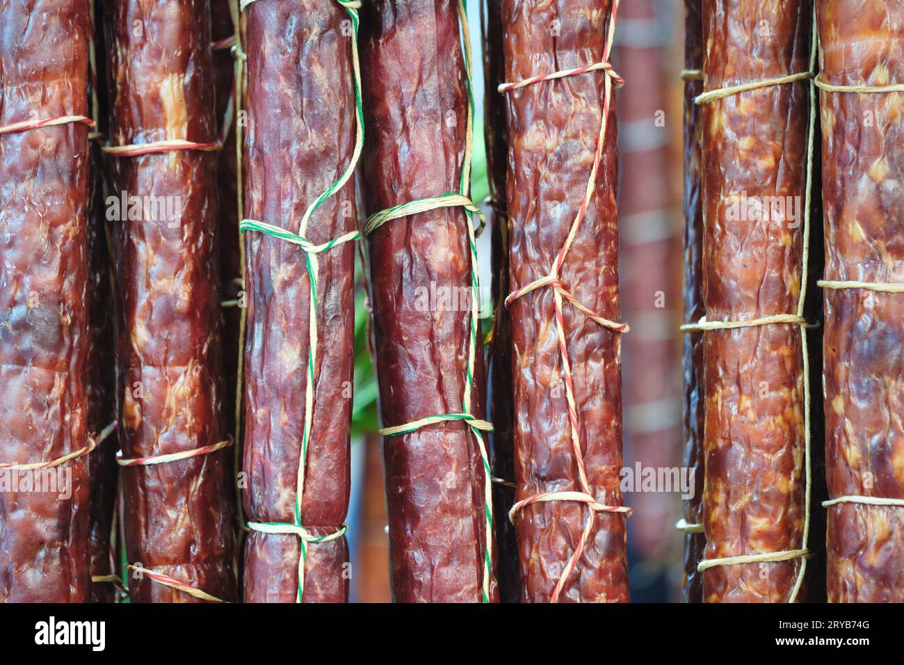 sausage meat production, Salami sticks drying on a rack Stock Photo Alamy