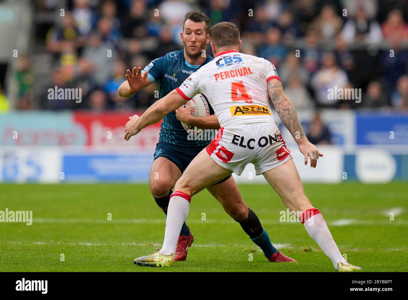 Stefan Ratchford #4 of Warrington Wolves runs at Mark Percival #4 of St ...