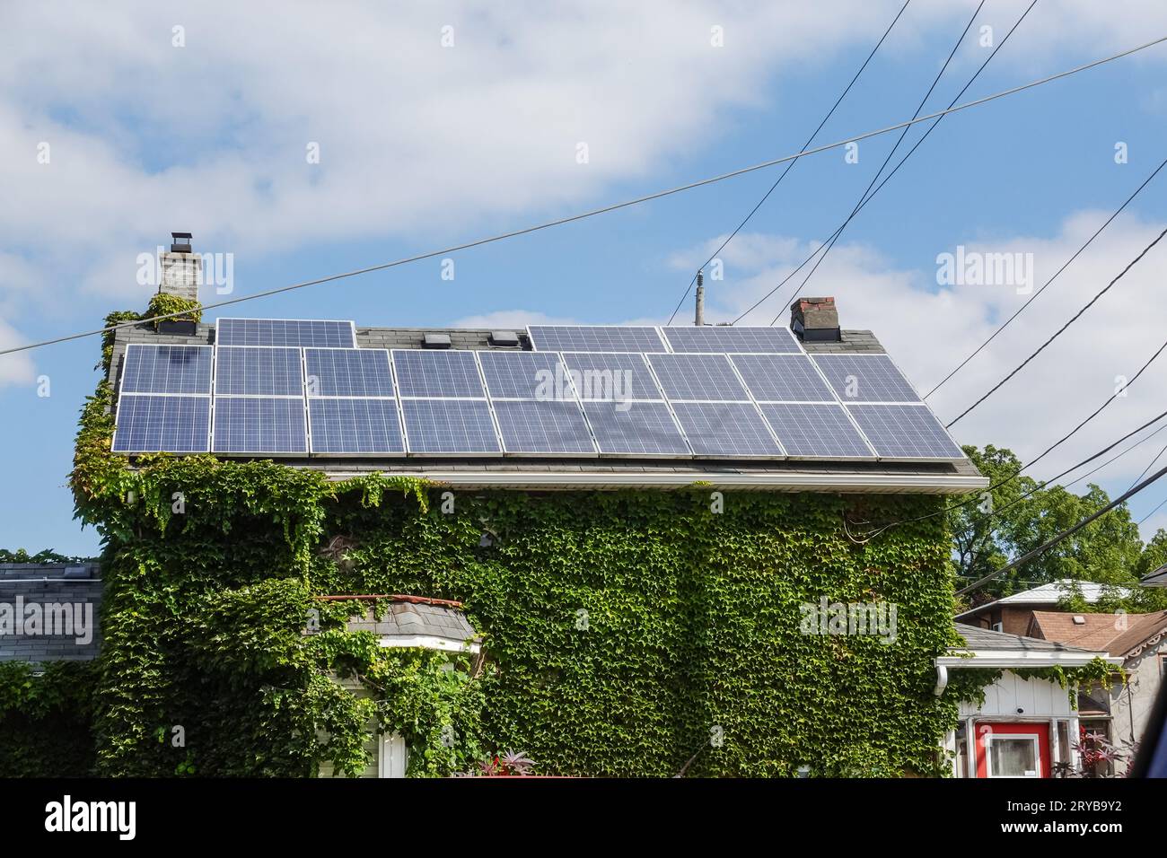 solar panels on top of a house on a sunny day Stock Photo