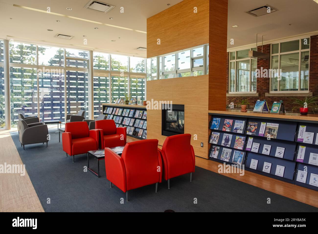 inside a library with magazine rack and comfortable sofa seating Stock Photo