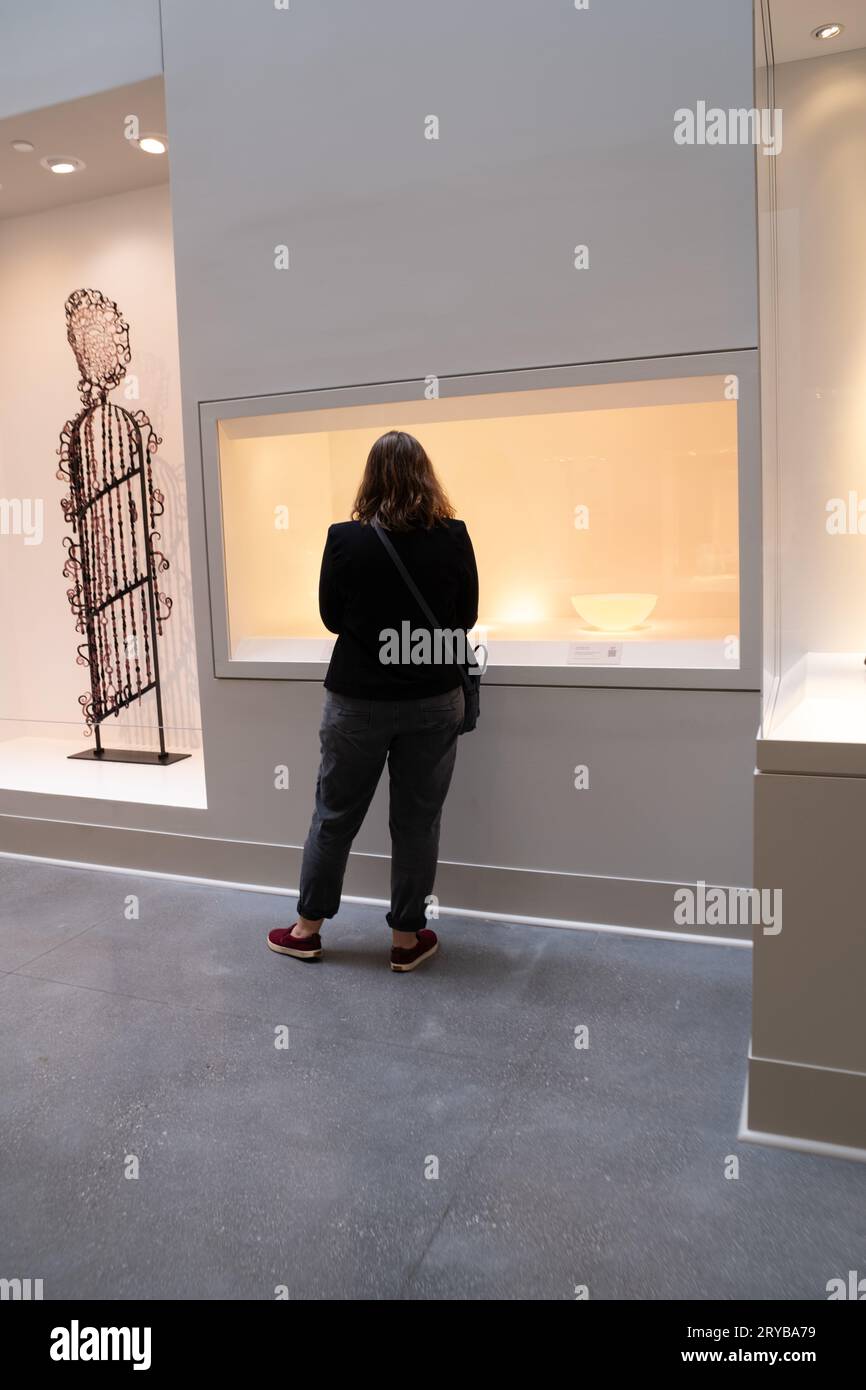 Woman looking at a contemporary glass exhibit at the Flint Institute of Arts Stock Photo
