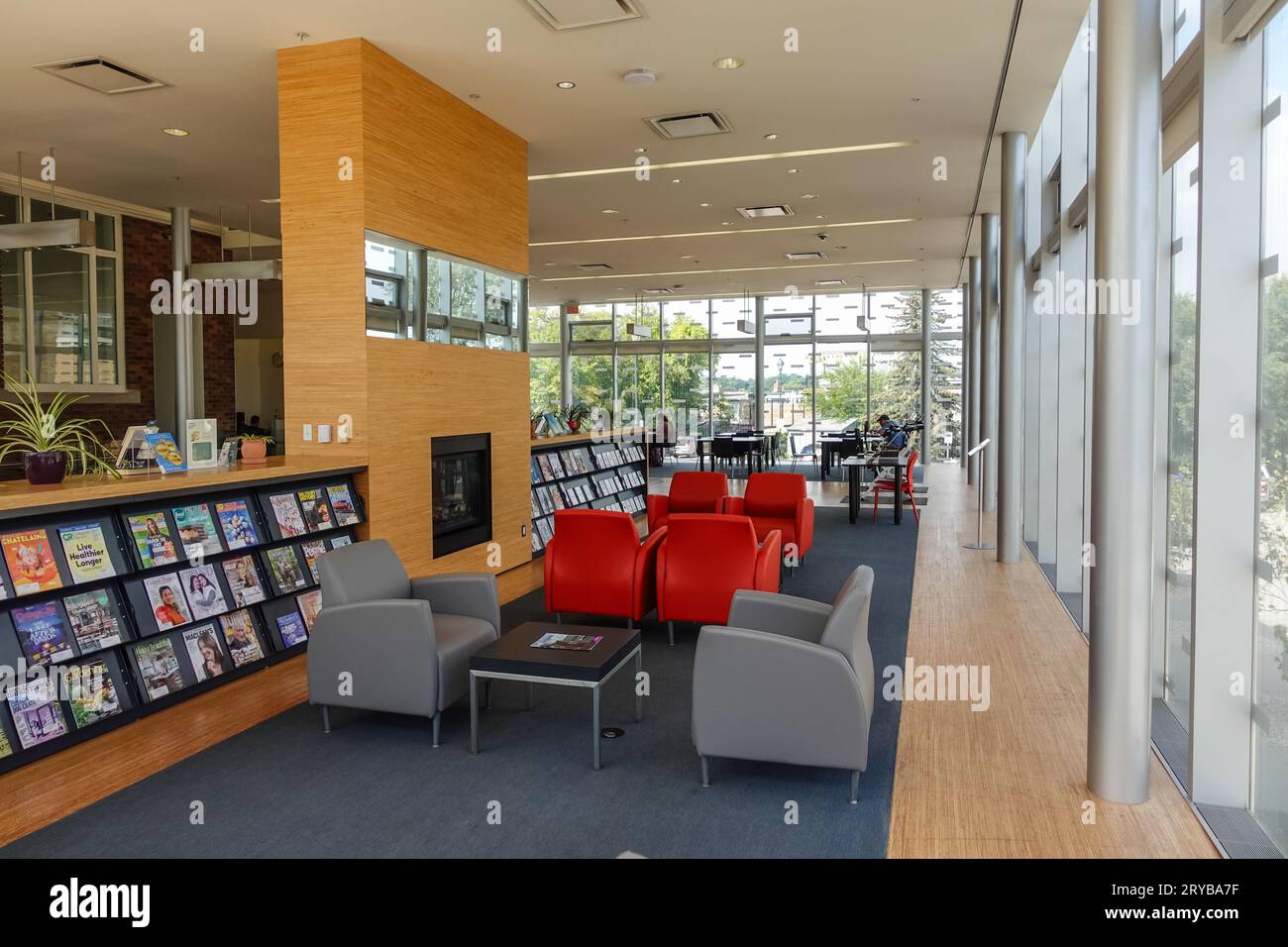 inside a library with magazine rack and comfortable sofa seating Stock Photo