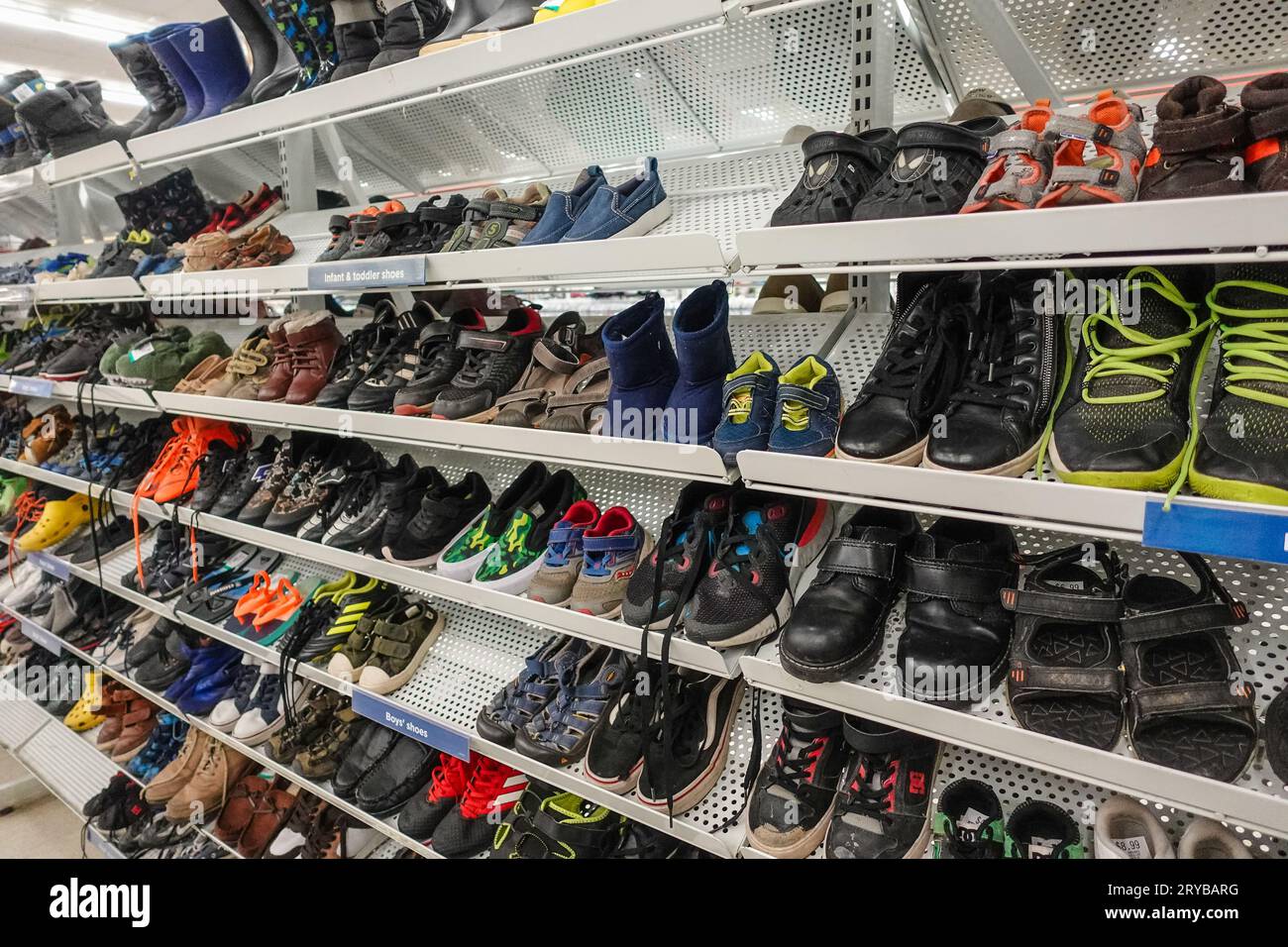 young boy used shoes for sale in a second hand store Stock Photo