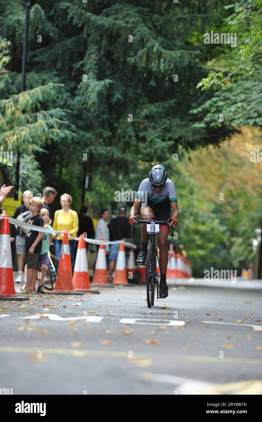 Cyclists strain as they race up Swains Lane, Highgate, London, UK in