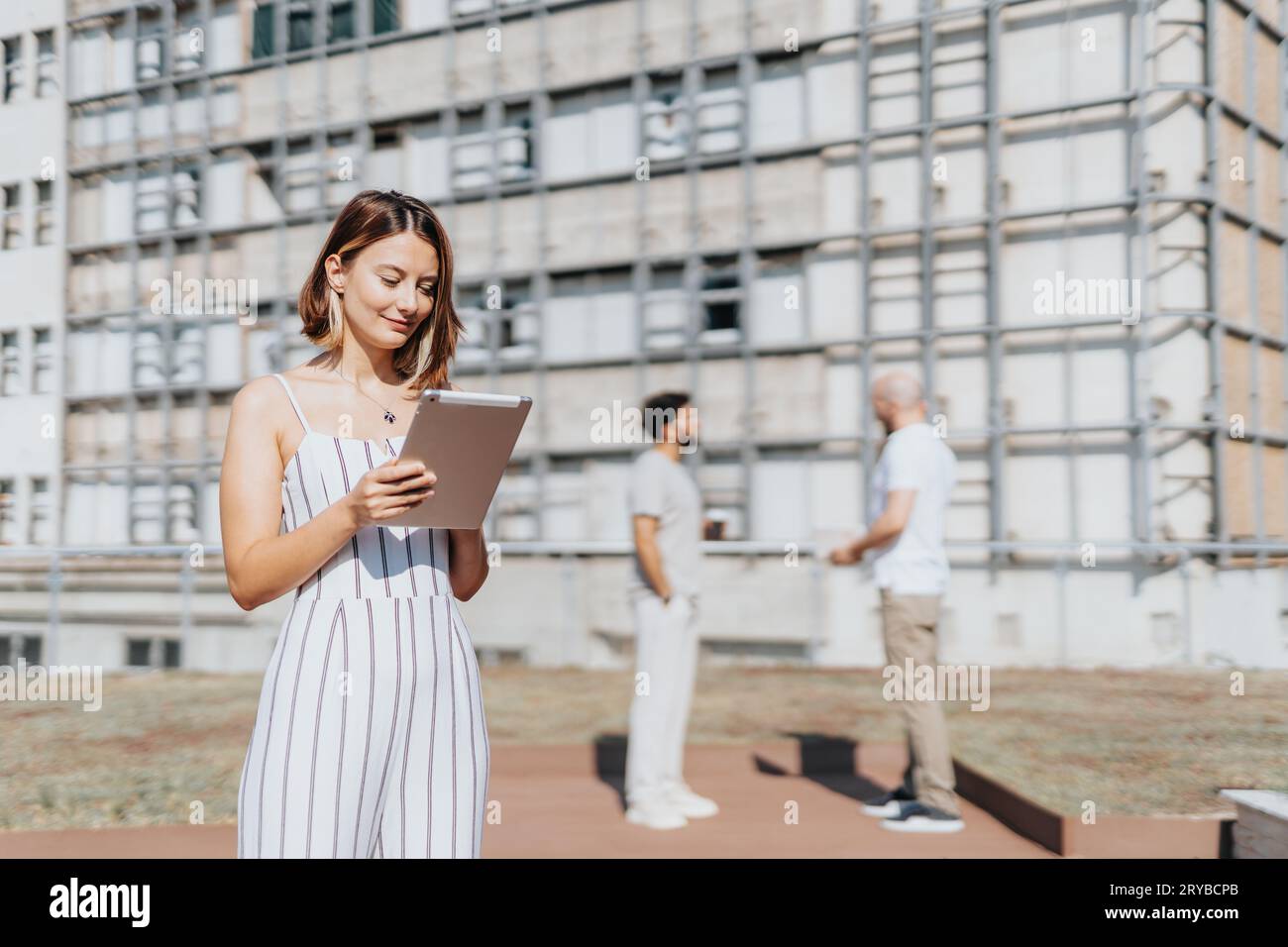 A diverse group of professionals collaborating on a construction project in the urban city. They discuss blueprints and analyze statistics to ensure s Stock Photo