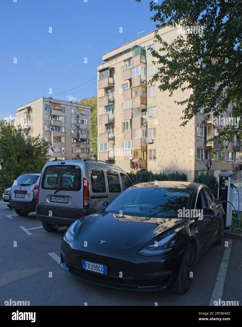 Gorazde, Bosnia and Herzegovina - Sep 29, 2023: A static shot of electric car charging at the EPBIH AC charging station in a sunny summer day. Selecti Stock Photo