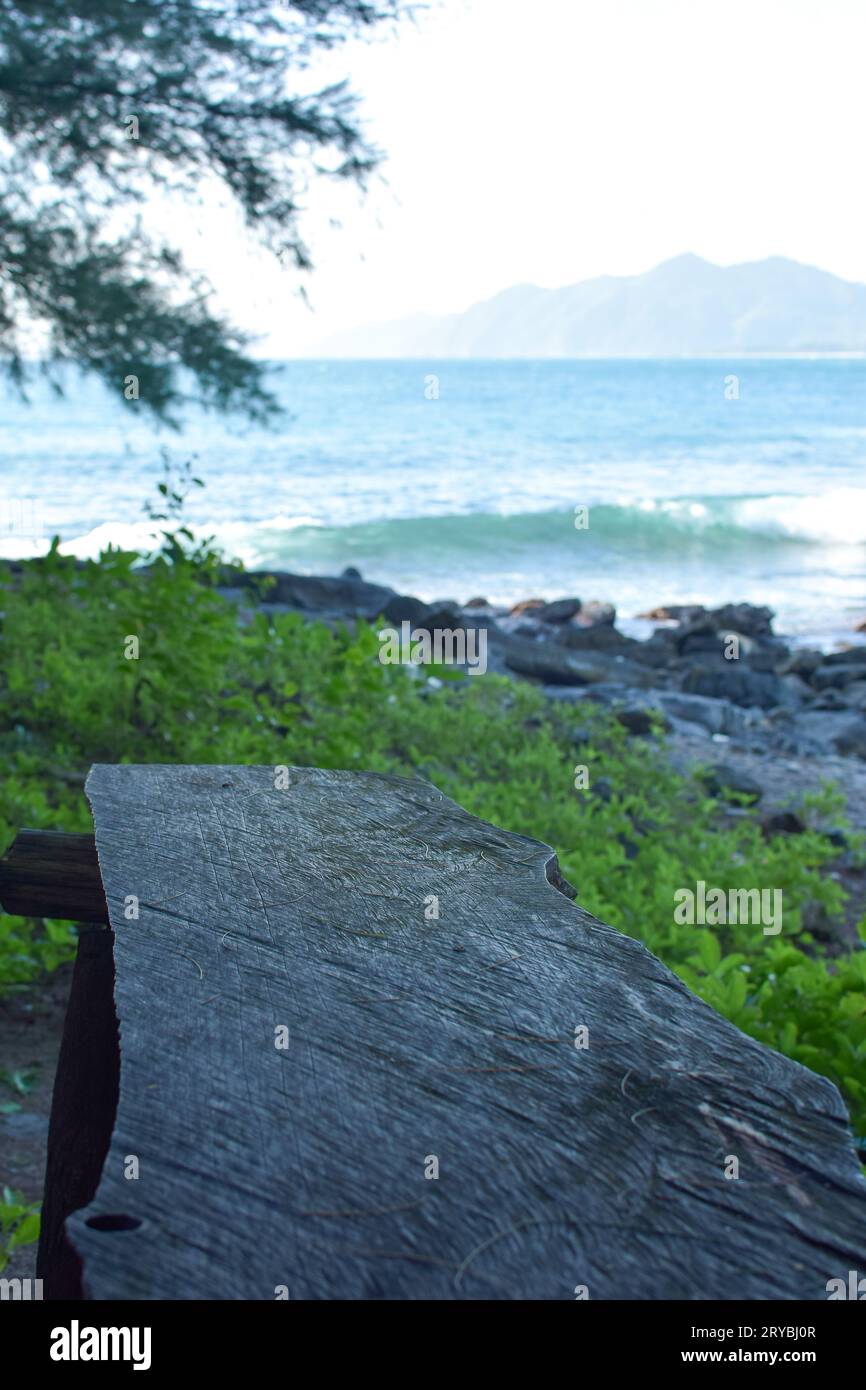 Aceh, Indonesia - September, 2023: Unidentified people at the beach and Rocks on the beach in the evening Stock Photo