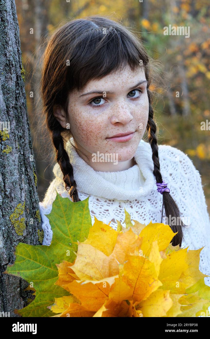 portrait of freckled teenage girl in the autumn park Stock Photo