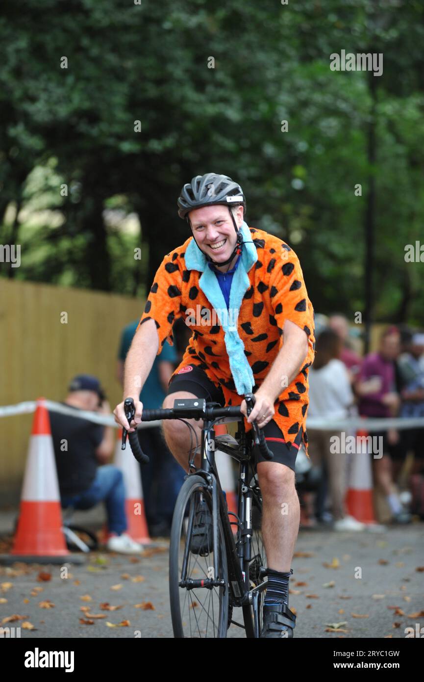 Cyclists strain as they race up Swains Lane, Highgate, London, UK in