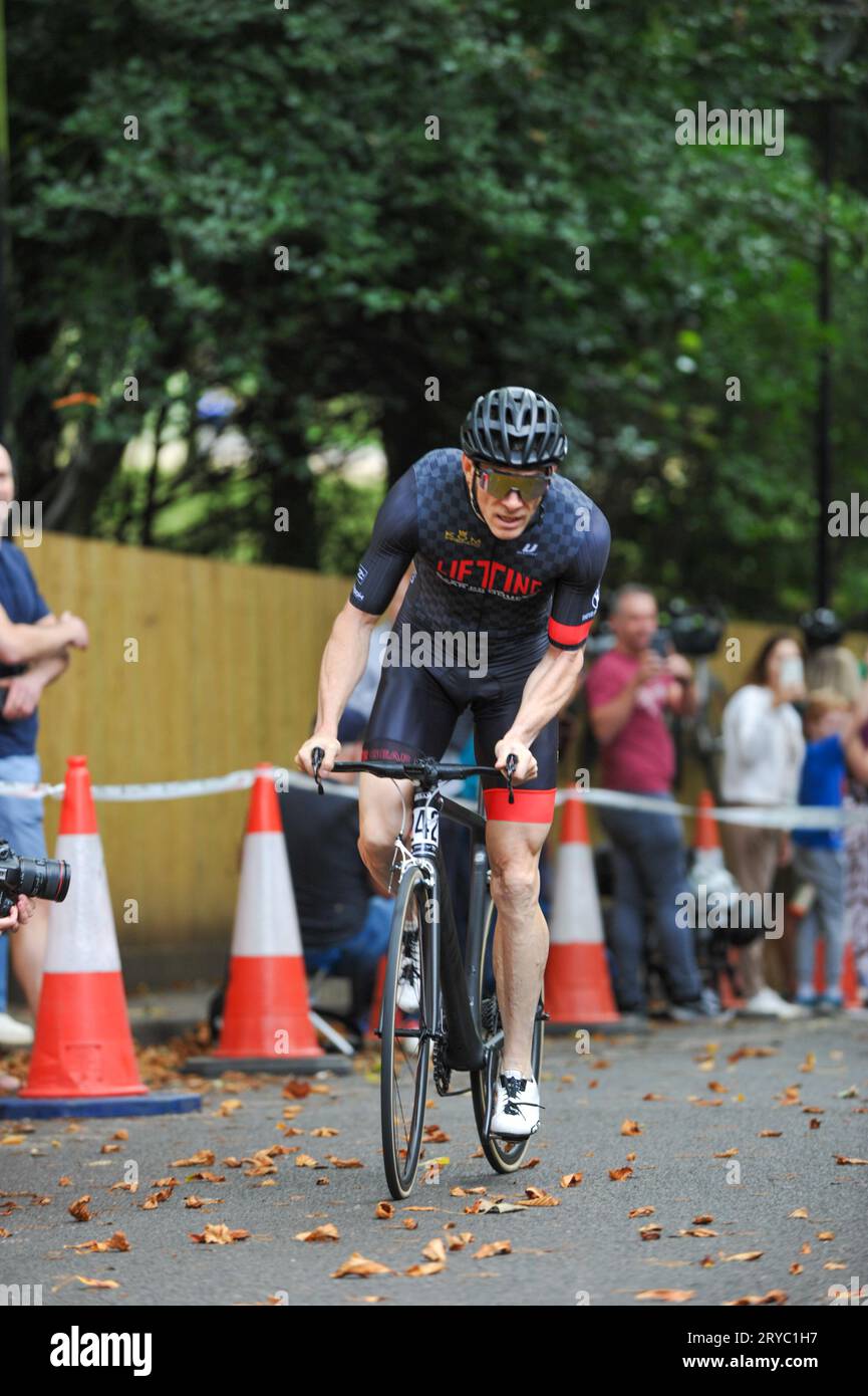 Cyclists strain as they race up Swains Lane, Highgate, London, UK in