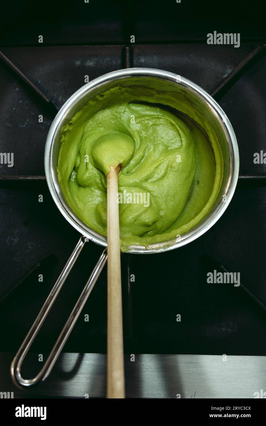 Frozen spinach in the pot prepared to cook. Green balls of frozen