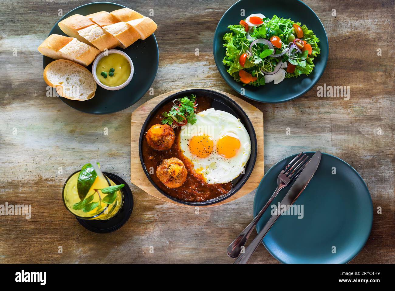 Vietnamese Banh mi chao dish with salted egg yolk meatballs, tomatoes