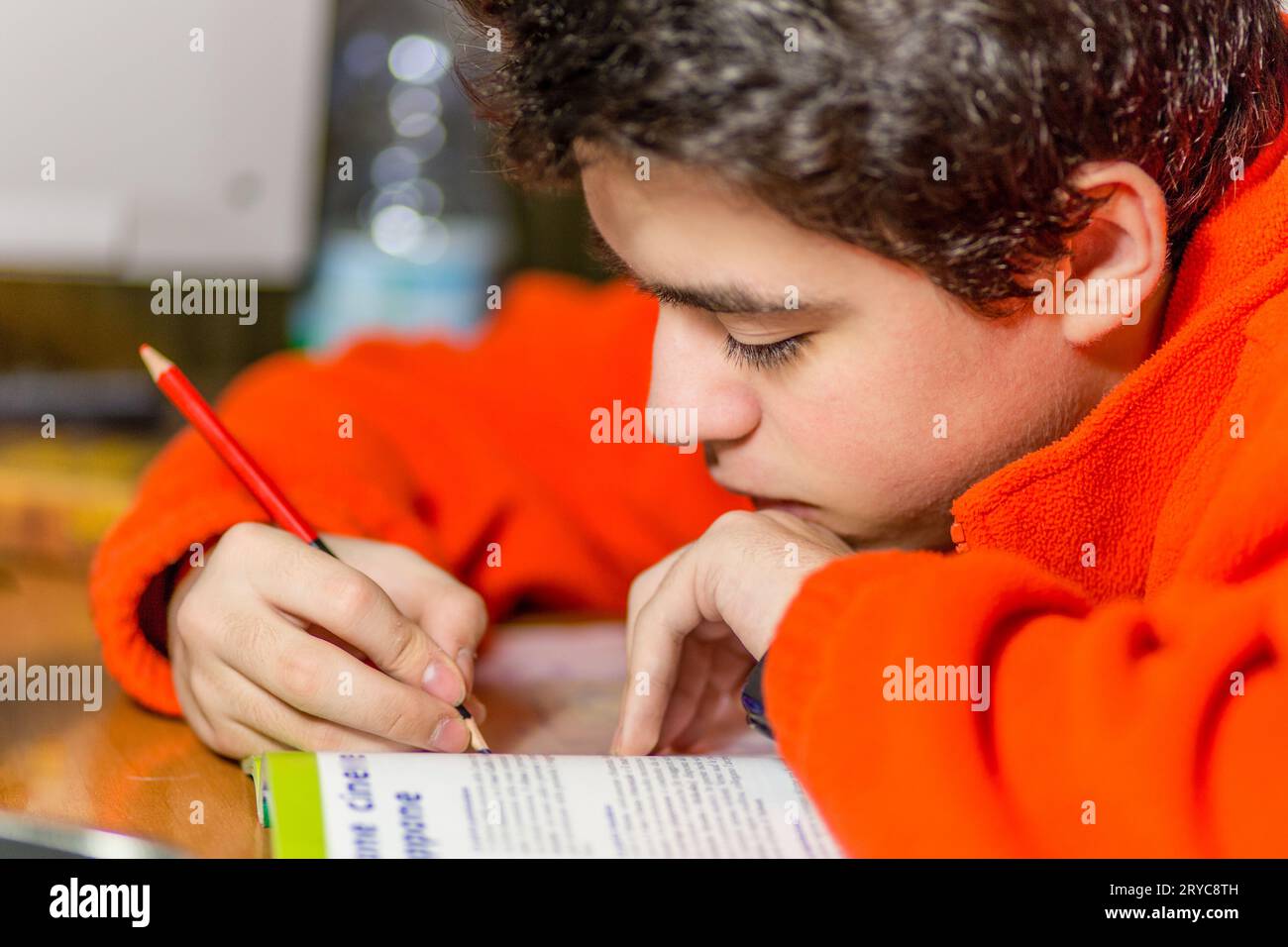 Boy writing with red and blue pencil Stock Photo