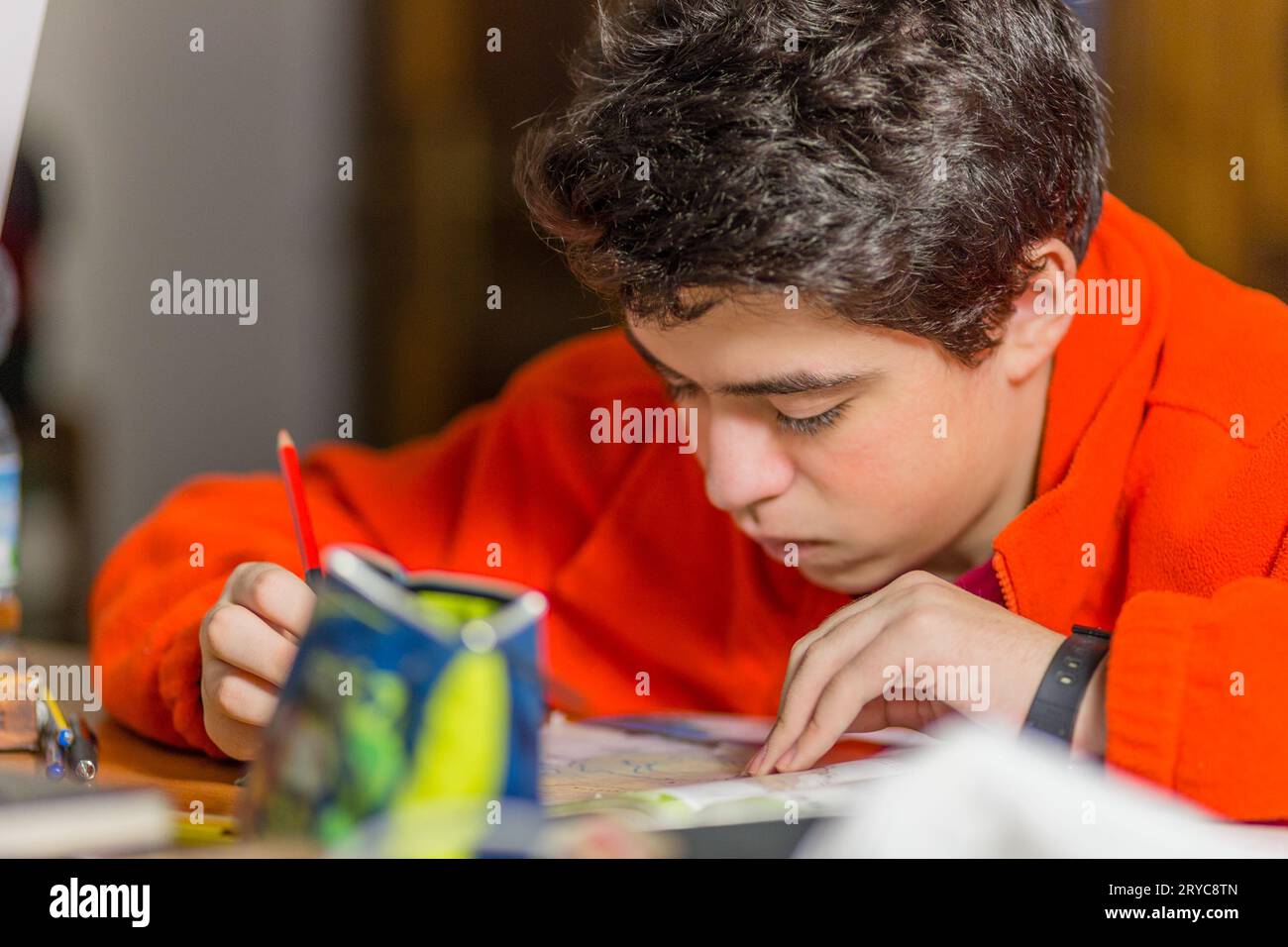 Boy writing with red and blue pencil Stock Photo