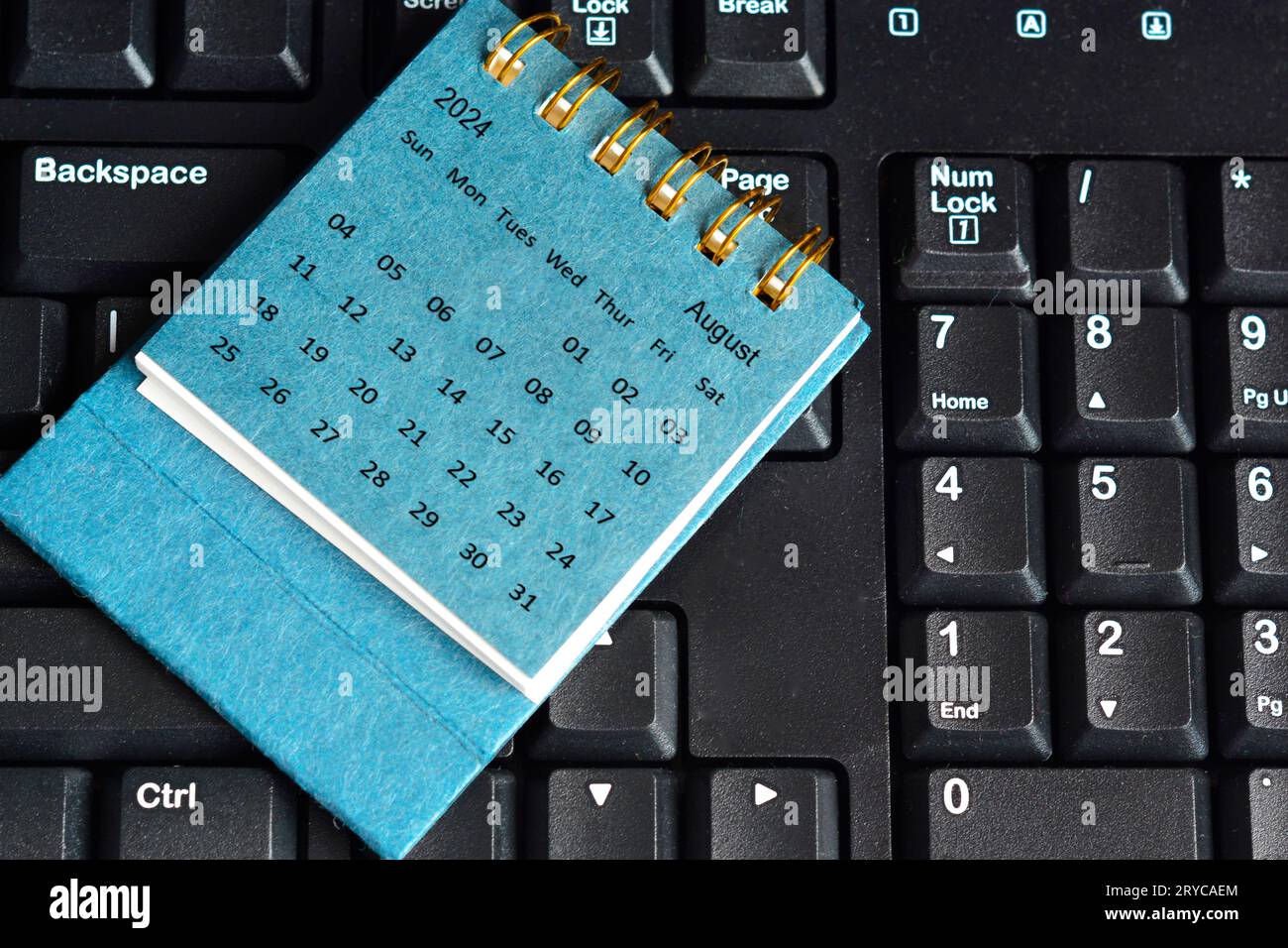 Blue August 2024 calendar on keyboard. 2024 New Year Concept Stock