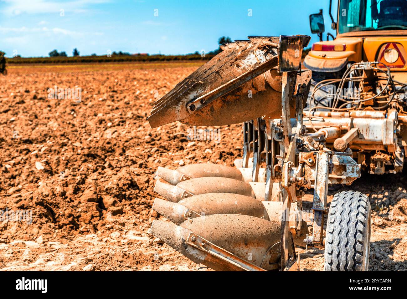 Parked tractor in front of plowed field Stock Photo - Alamy