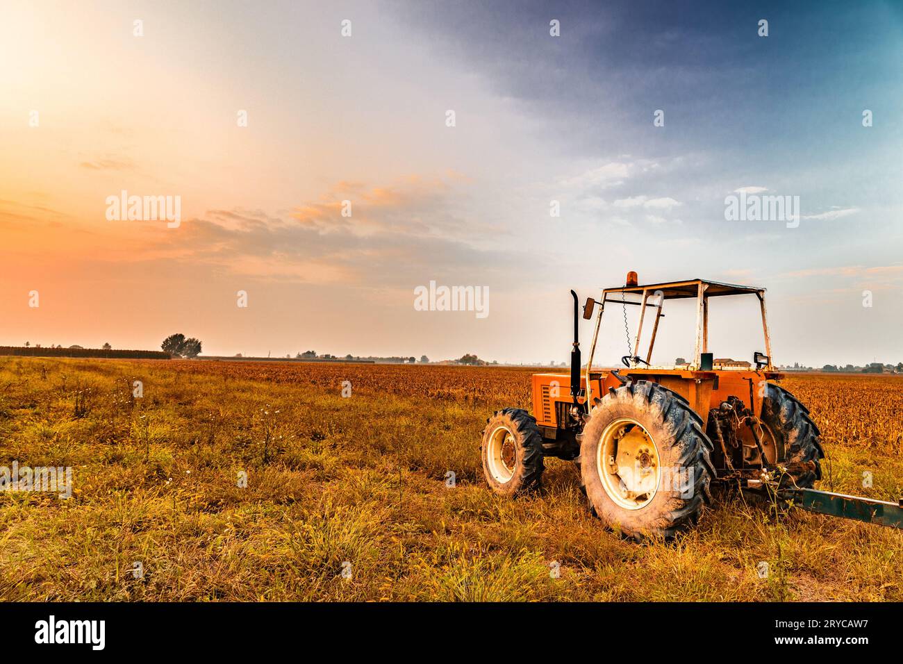 Tractor and harvested land Stock Photo - Alamy