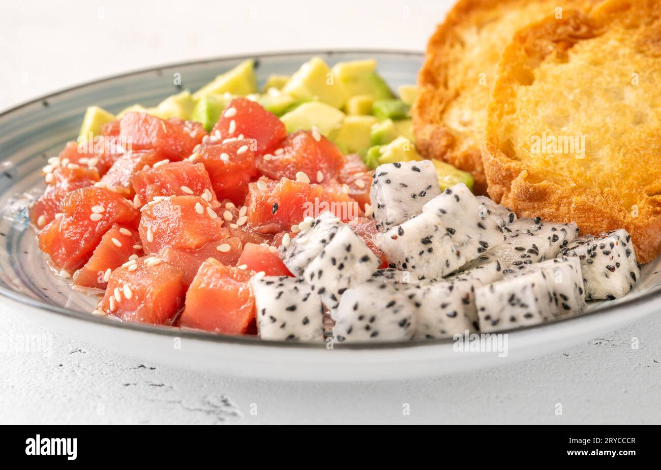 Portion of Hawaiian poke with tuna, pitaya and avocado Stock Photo