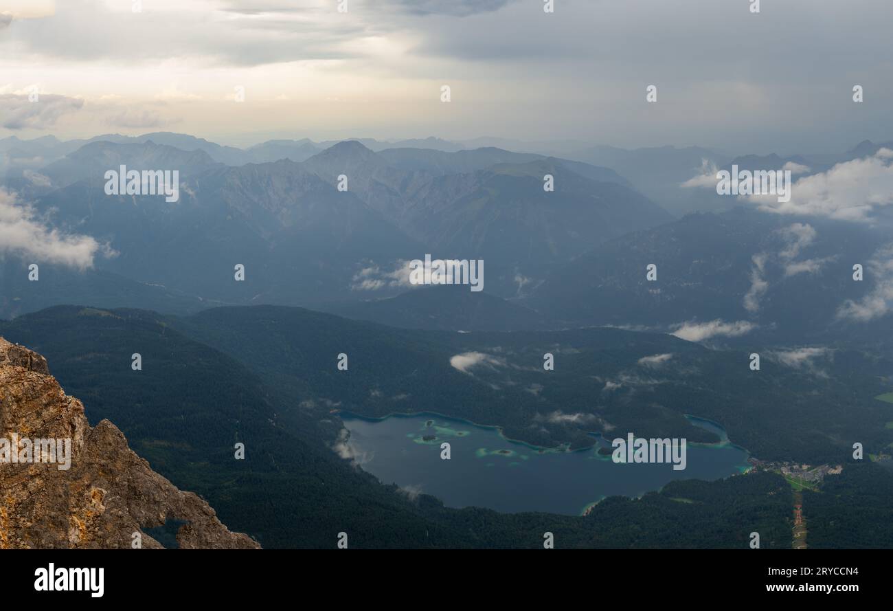 Eibsee as seen from Mount Zugspitze after a thunderstorm with dark clouds at dusk Stock Photo