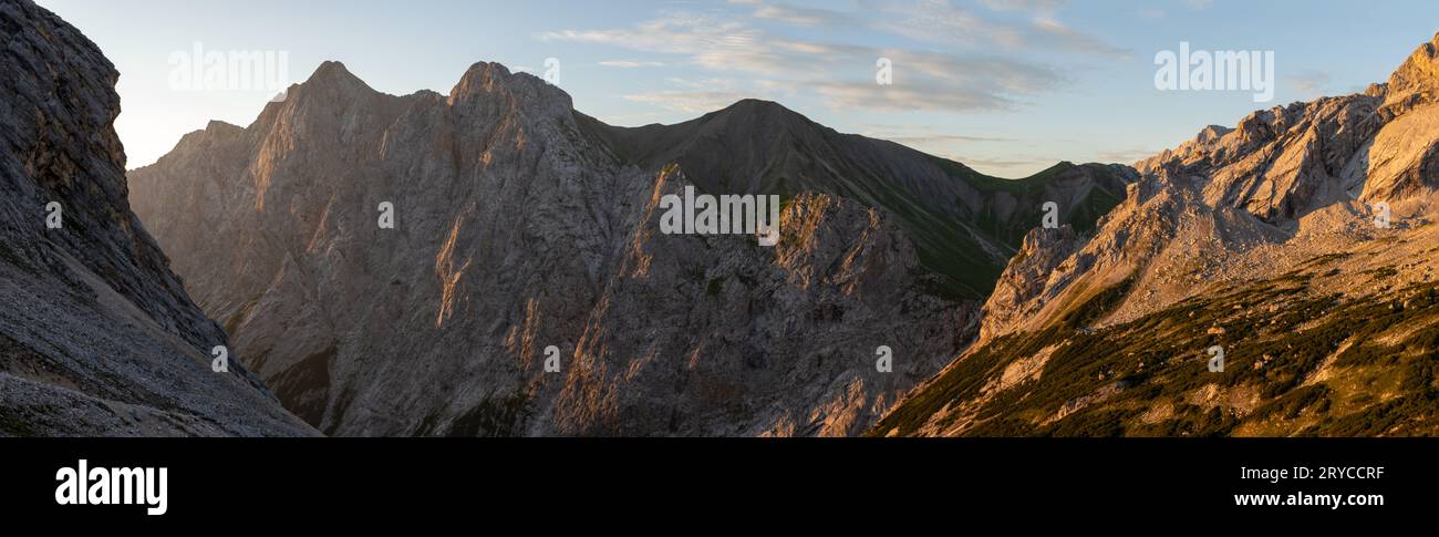 Hochwanner, Kleiner Wanner and Hoher Kamm peaks in Wetterstein Mountains in the Alps during golden hour sunrise Stock Photo