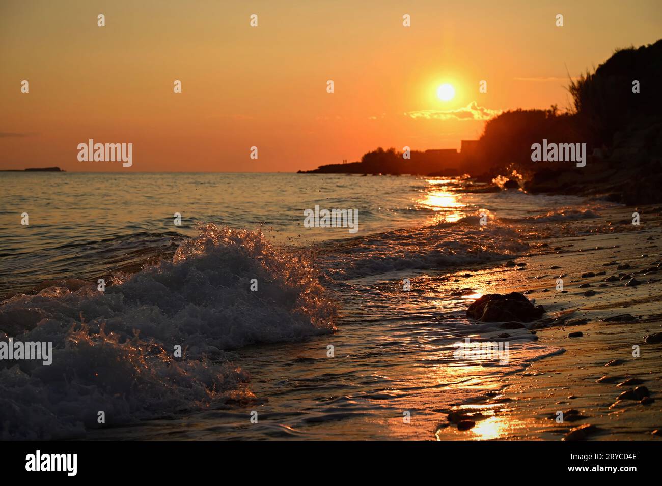 Beautiful sunset on the beach with the sea. Greece - island of Corfu (Kerkyra). Concept for travel, holidays and summer vacations. Stock Photo