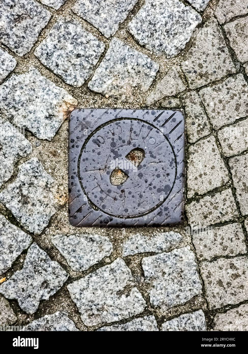 Manhole cover of the gas pipeline system. A massive metal hatch for access to city communications in the pavement. Stock Photo