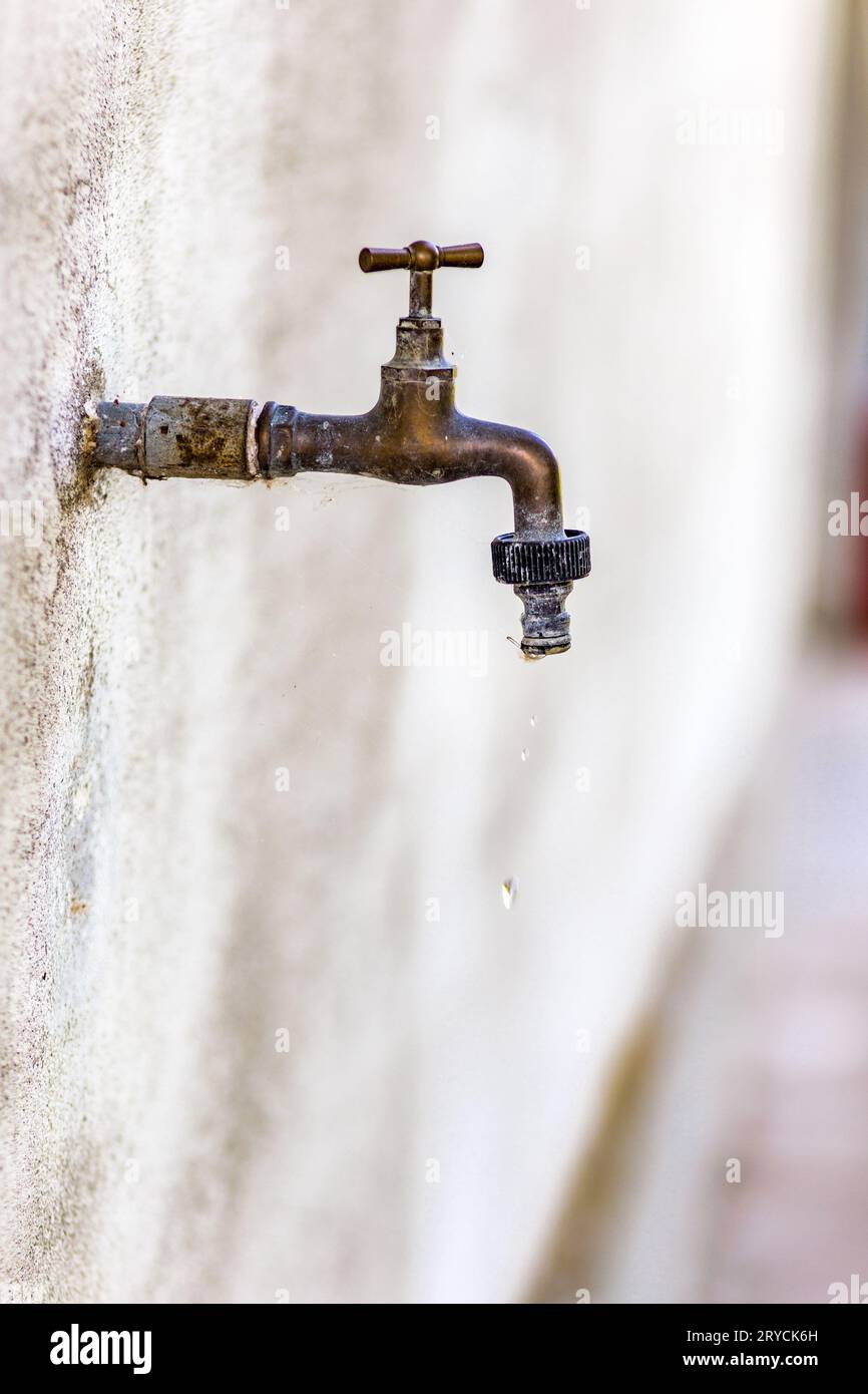Old rusty faucet leaks Stock Photo