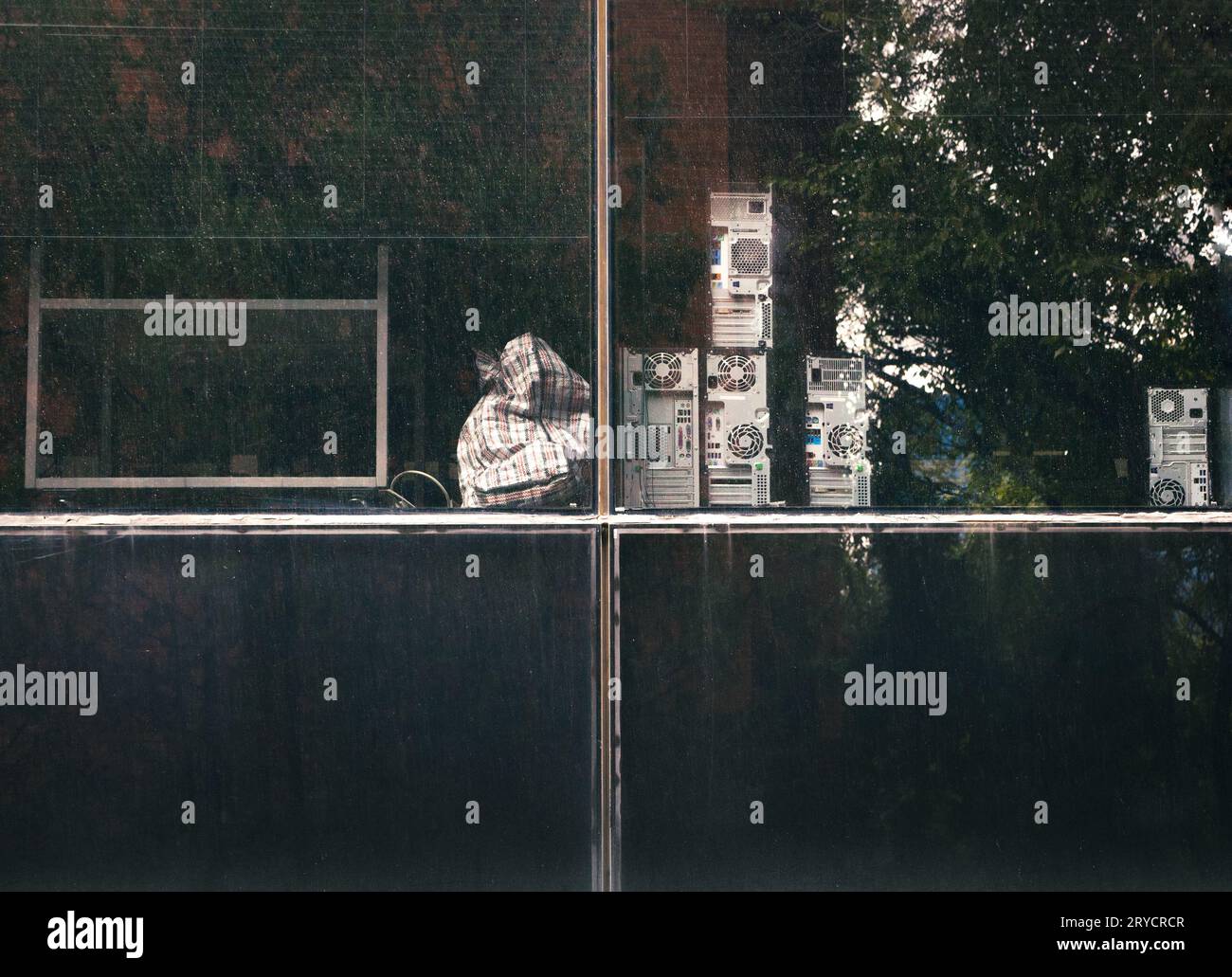 View of obsolete office supplies and equipment through rainstreaked