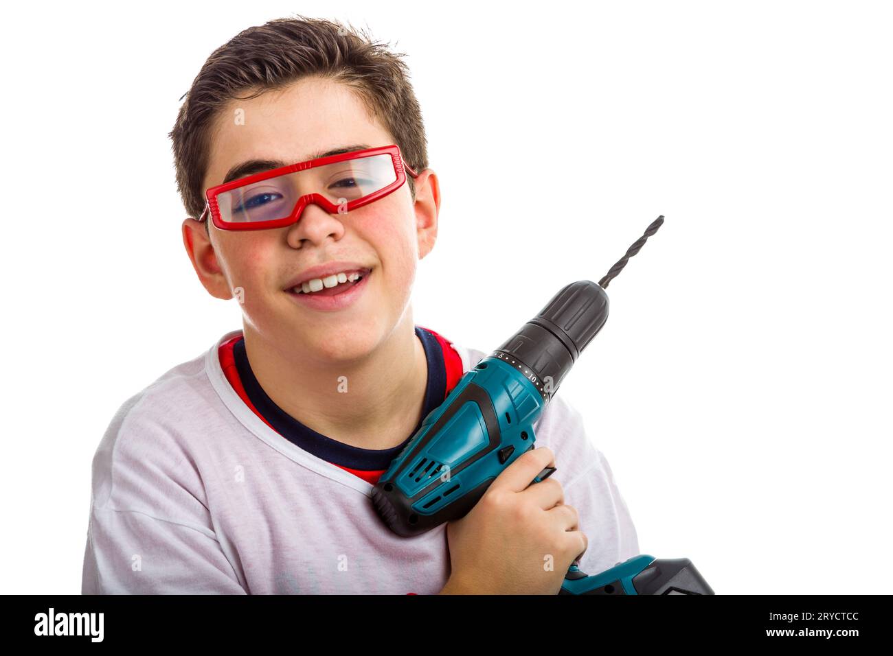 Child wearing red goggles and holding a cordless drill Stock Photo