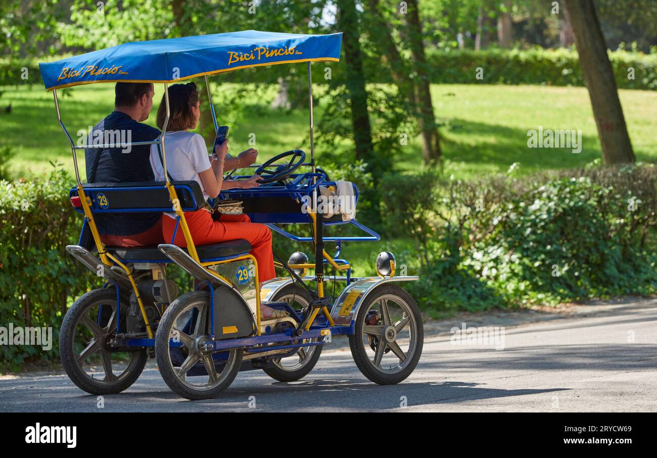 Vehicle on rent in the park of Villa Borghese on a sunny day, Rome Stock Photo