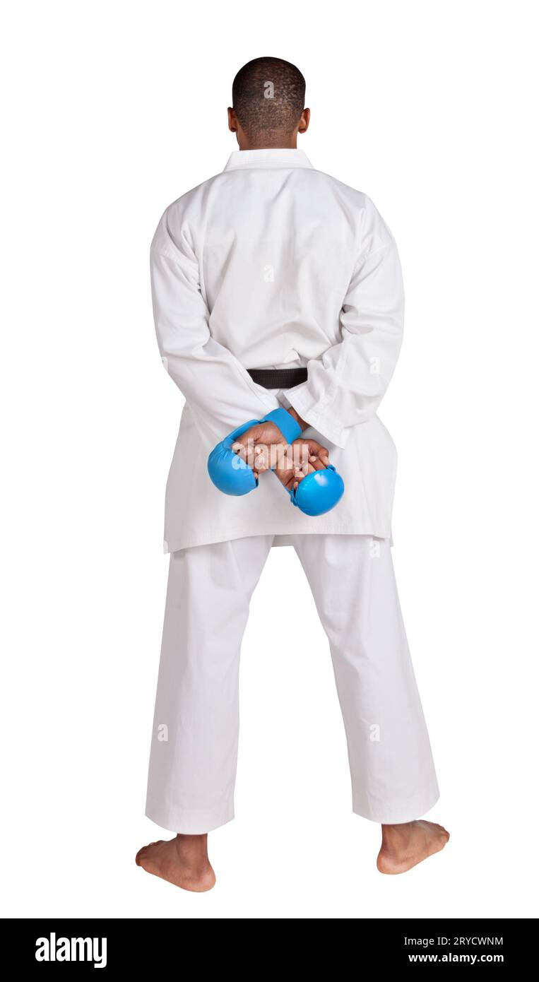 african american karate man, standing with the back,  in white  kimono  uniform with belt and gloves Stock Photo