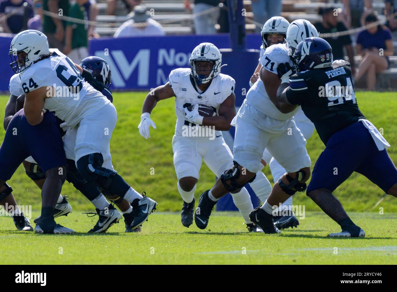 EVANSTON, IL - SEPTEMBER 30: Penn State Nittany Lions running back Kaytron  Allen (13) runs the ball while being guarded by Penn State Nittany Lions  offensive lineman Hunter Nourzad (64) and Penn