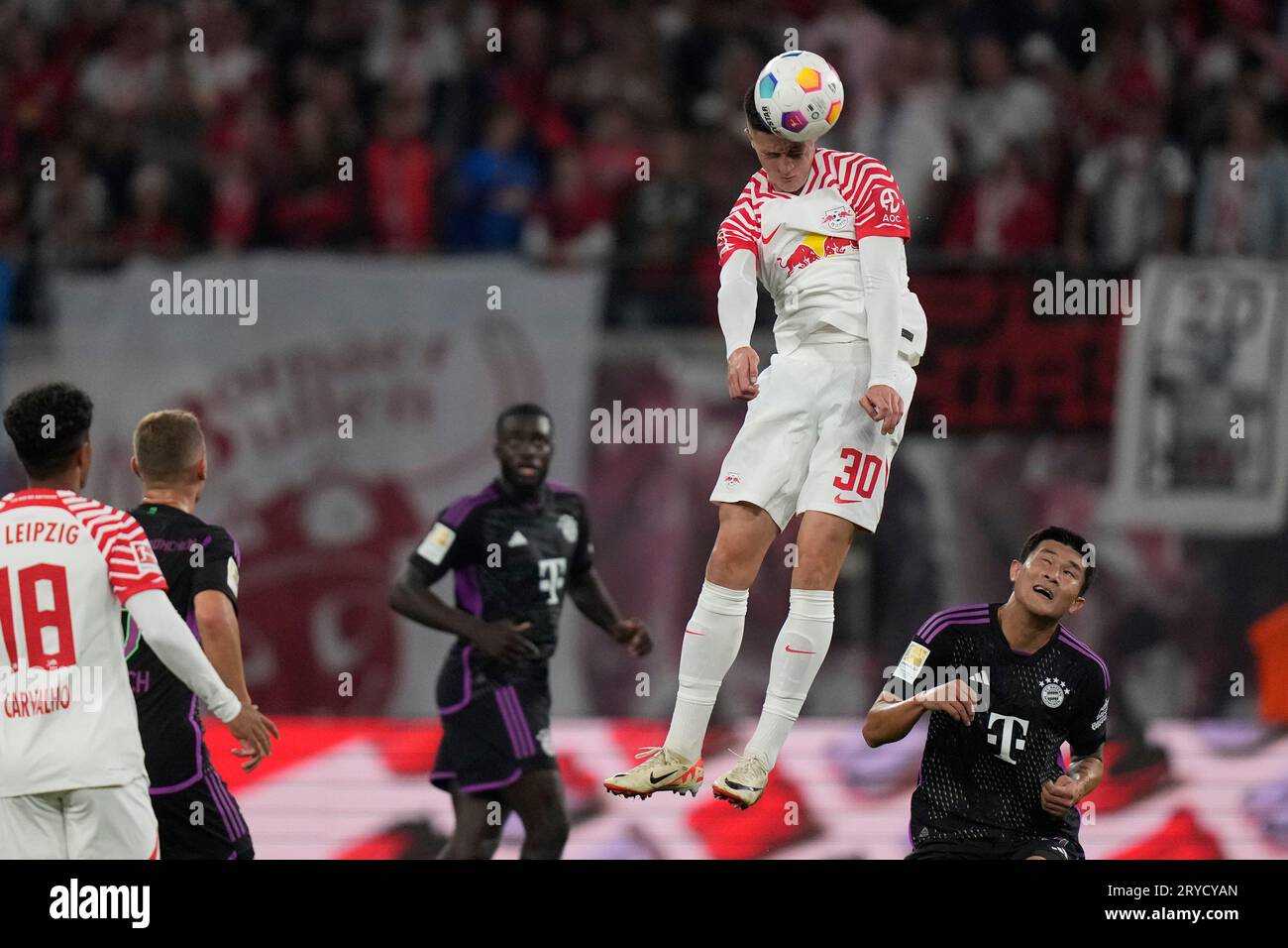 Leipzig's Benjamin Sesko, top, heads the ball during the German