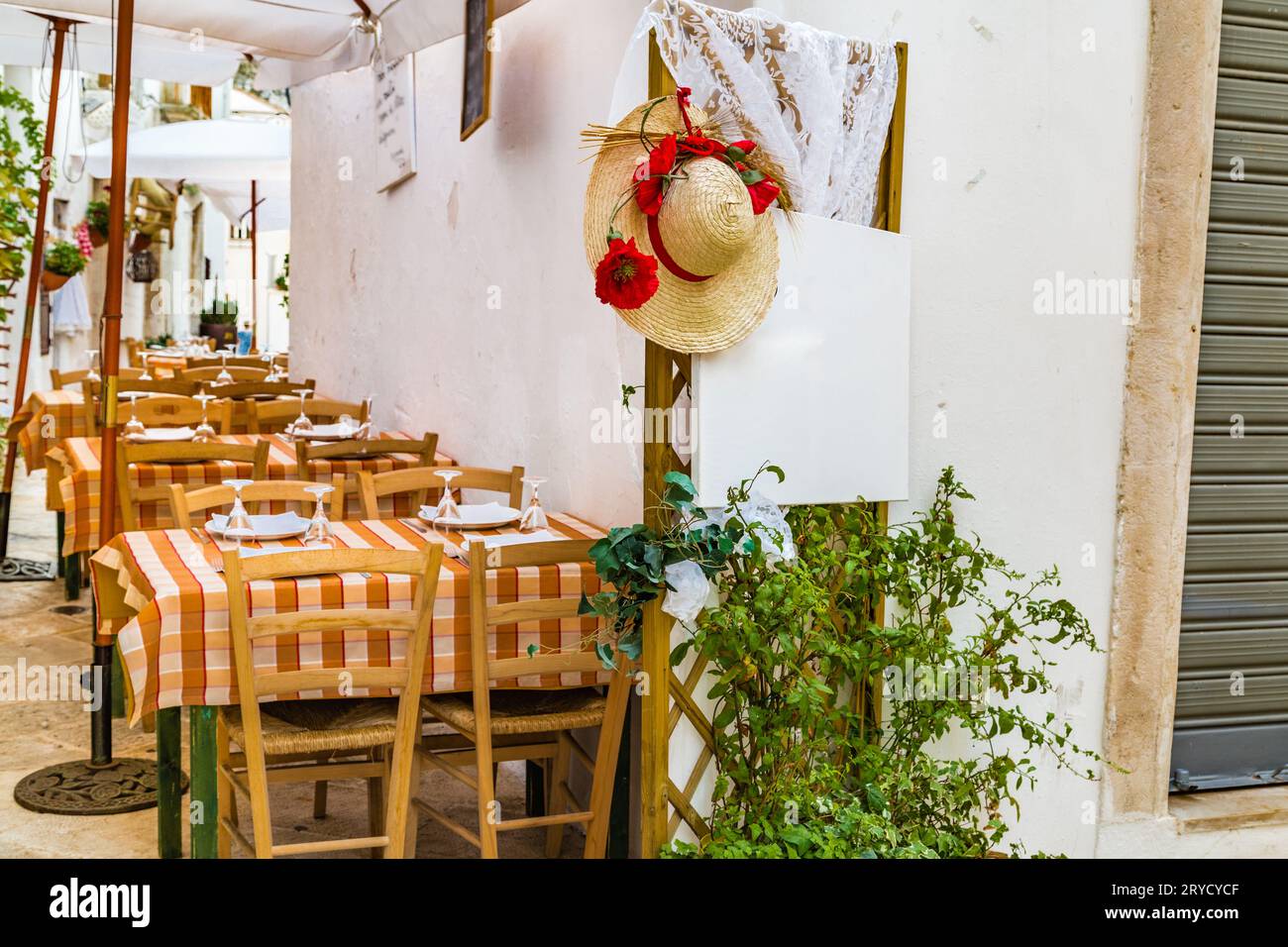 Restaurant among whitewashed houses of Locorotondo Stock Photo