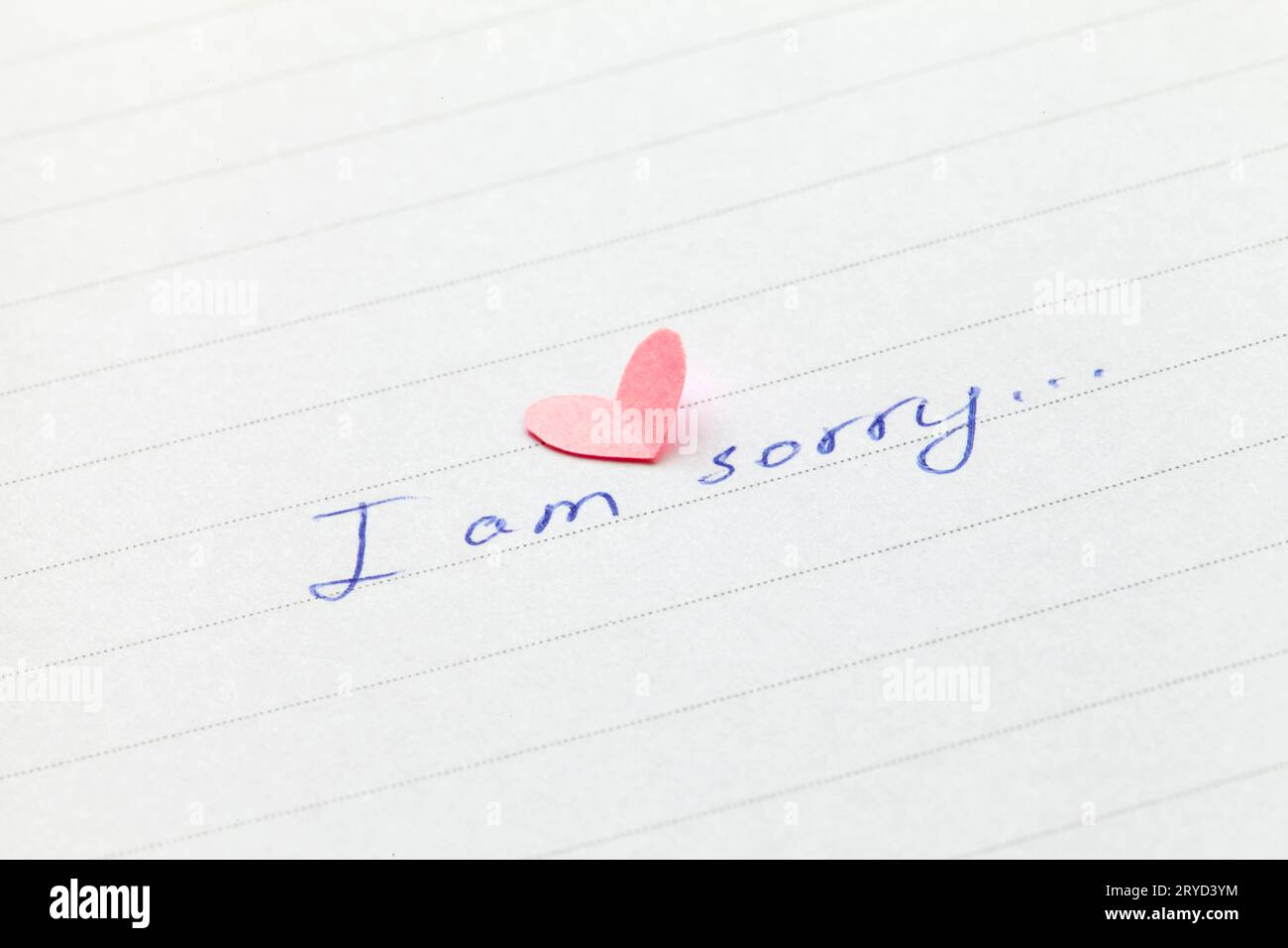 Handwritten phrase I am sorry with heart. Shallow depth of field. Stock Photo