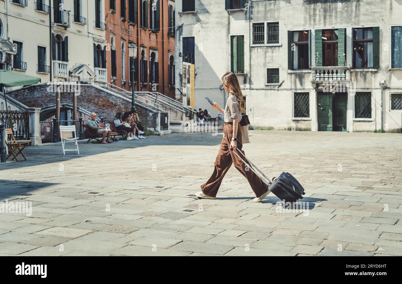 Venice, Italy May 31 2023 Solo female traveller with a luggage