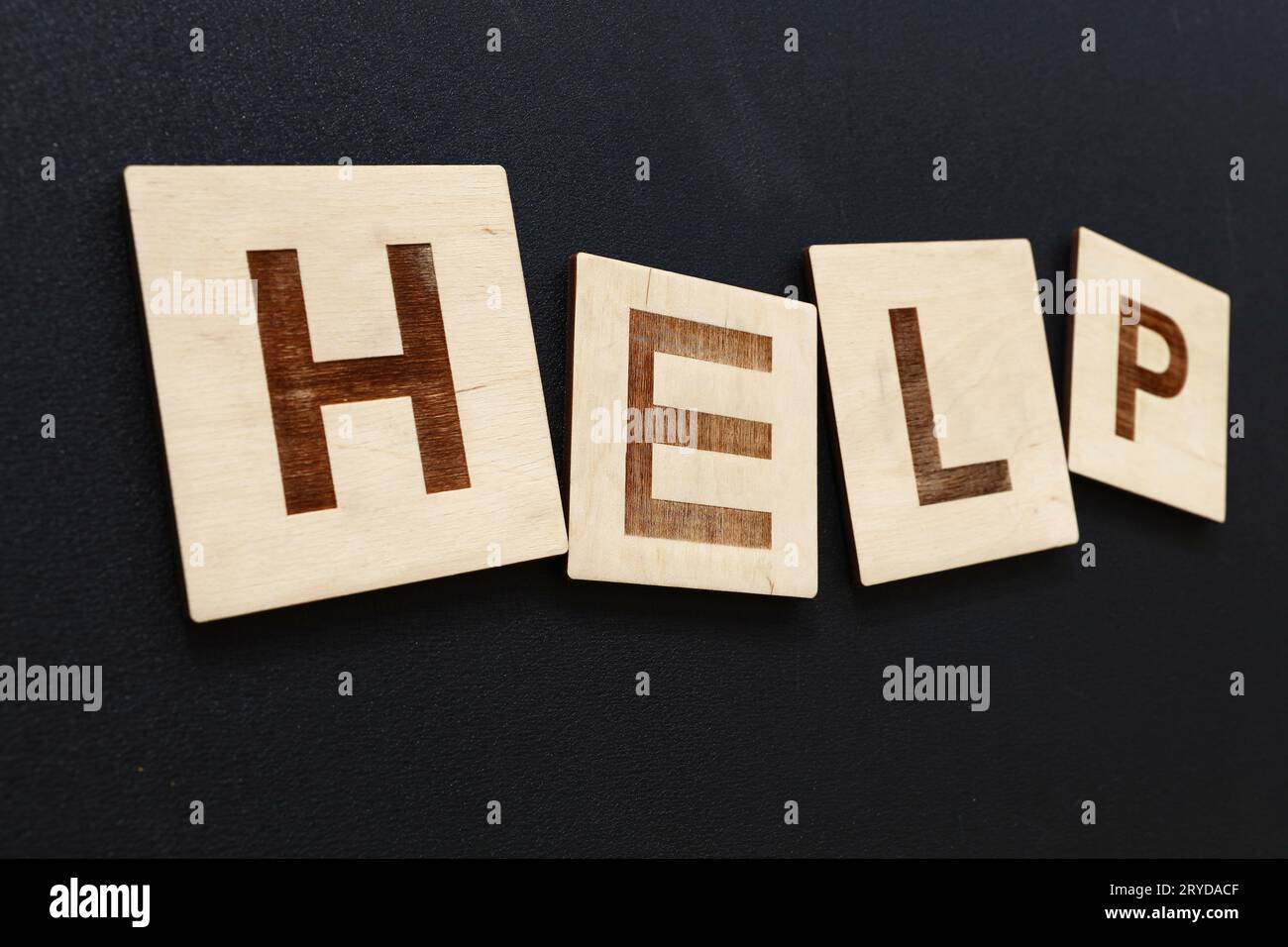 Word HELP on wooden signs over black Stock Photo - Alamy