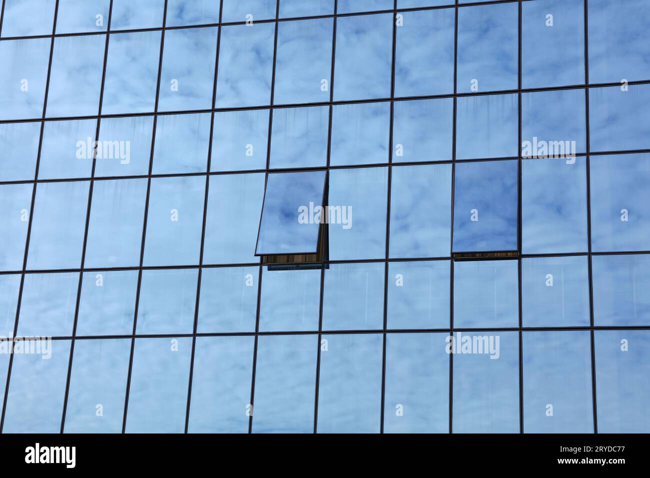 Cloudy sky reflection in business building glass Stock Photo - Alamy