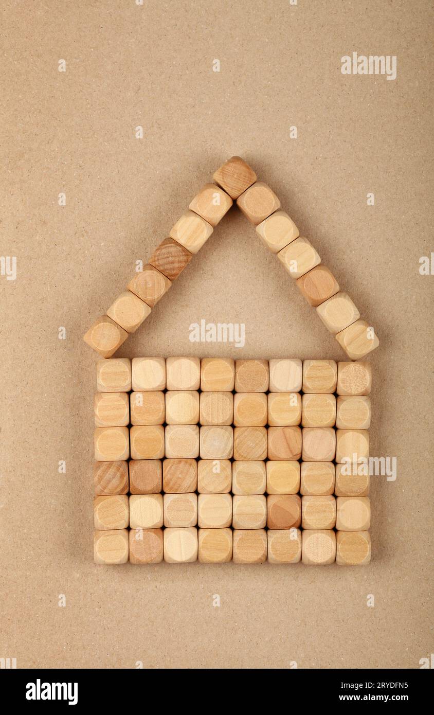 Wooden toy building blocks in shape cottage house Stock Photo