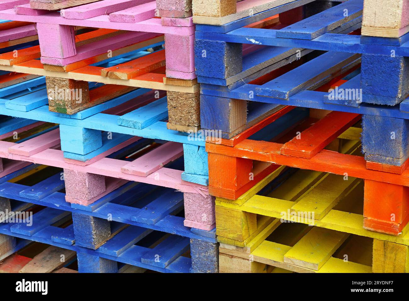 Stack of many multicolor painted wooden pallets Stock Photo Alamy