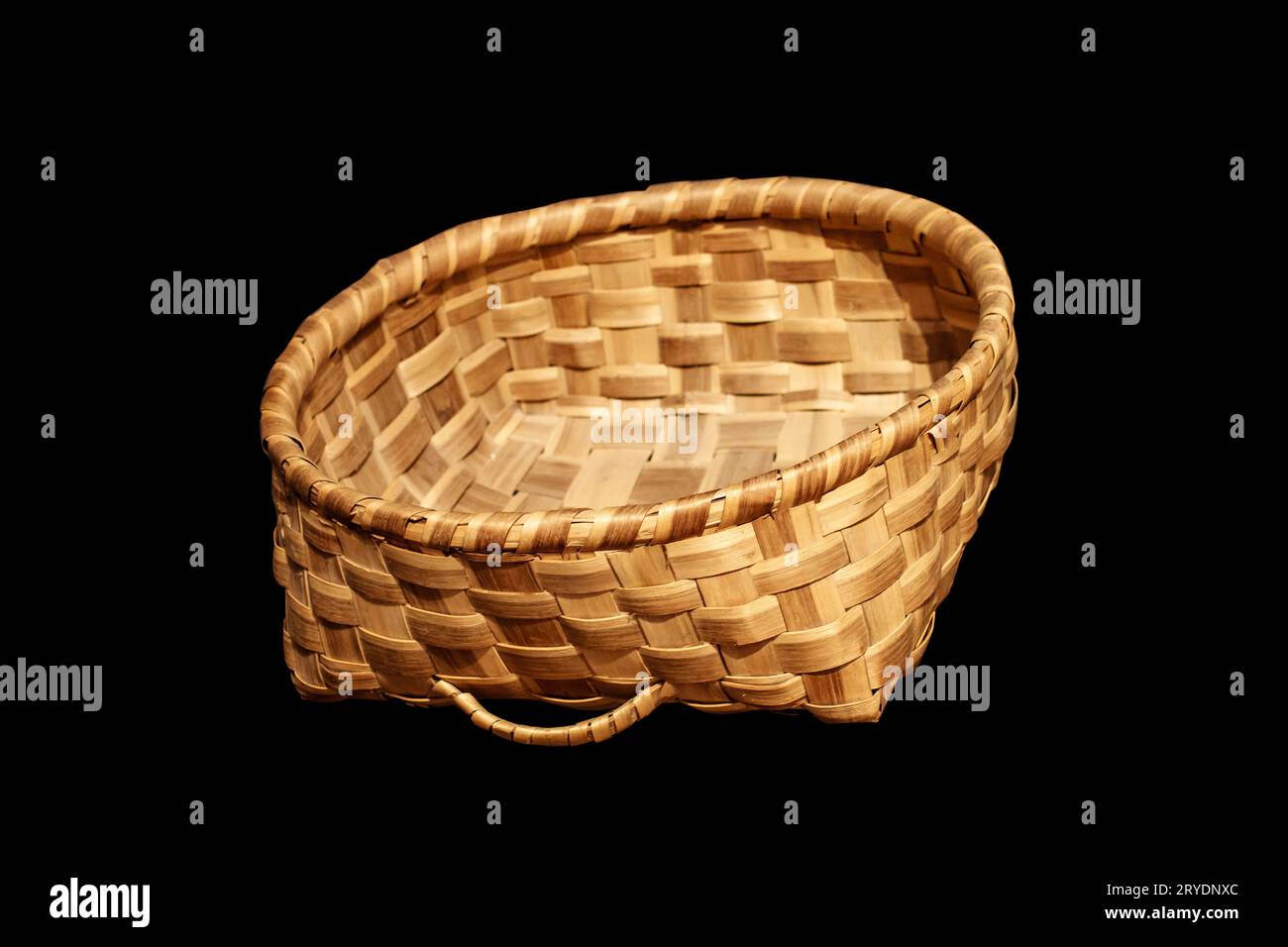 Traditional wicker basket isolated on black background Stock Photo