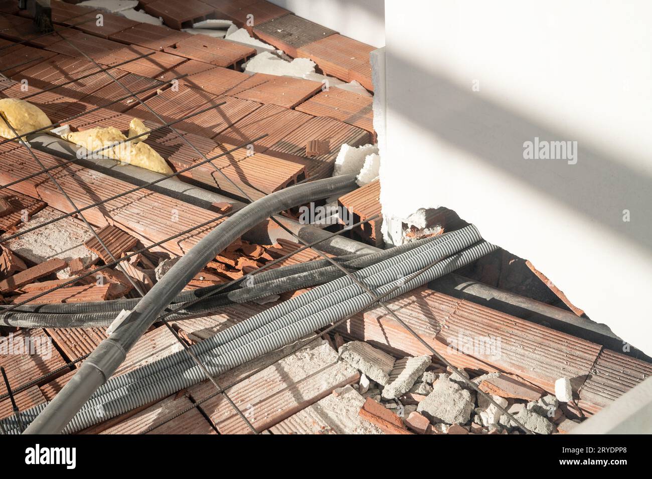 Wire mesh steel and piping for electrical wiring on floor Stock Photo